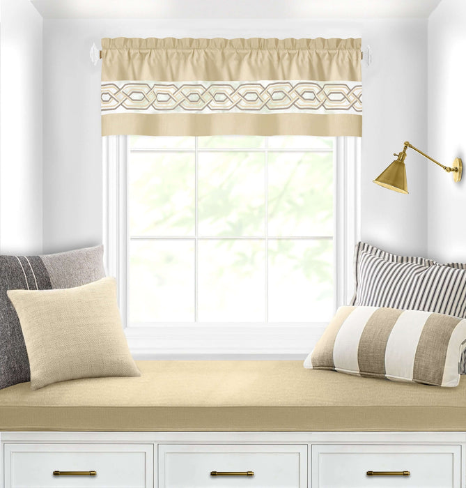 Window with light-filtering beige curtain valance, geometric embroidery, and 1.5-inch rod pocket, in cozy reading nook with cushions.