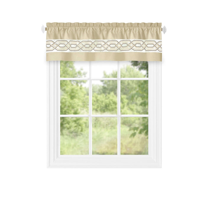 Beige window curtain valance with geometric pattern on a white window frame, filtering light into a bright, green outdoor view.